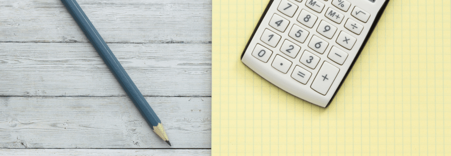 A wooden desk with a pencil, yellow graph paper and a calculator